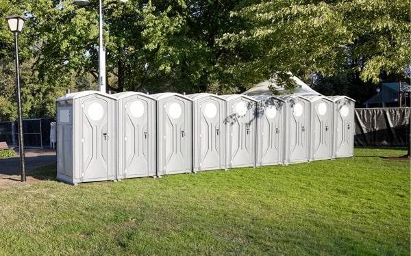 Construction site portable toilets positioned near an active Missouri City, TX job site