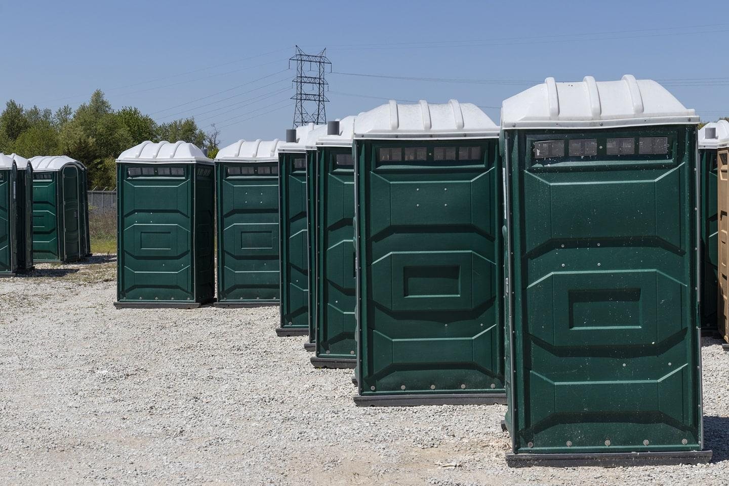 Row of clean portable toilets delivered to a job site in Missouri City, TX